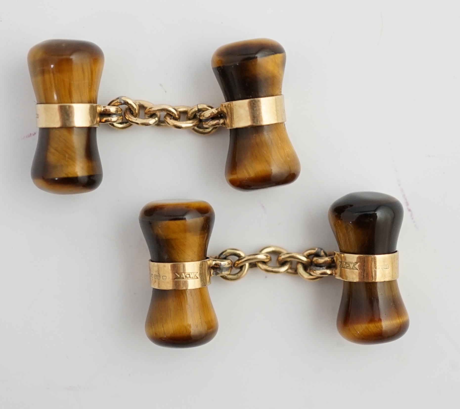 A pair 1970's 9ct gold and tigers eye quartz set dumbbell cufflinks